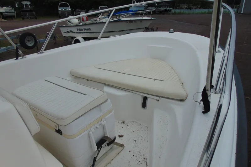 Slide: The Image of 2002 Boston Whaler 160 Dauntless boat interior with seating and storage. - 11