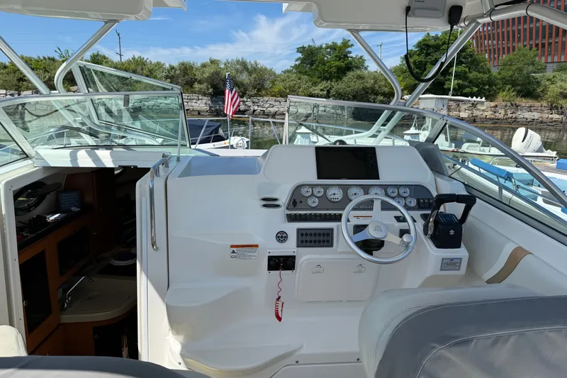 Slide: The Image of 2006 Wellcraft 290 Coastal boat cockpit with steering wheel and control panel. - 6