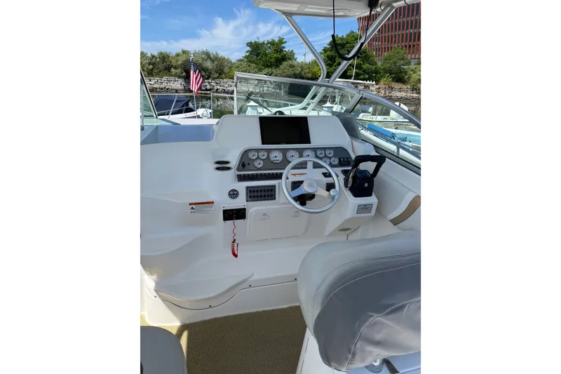 Slide: The Image of 2006 Wellcraft 290 Coastal boat helm with steering wheel, gauges, and controls. - 5
