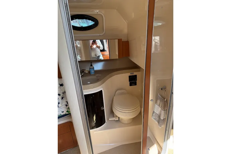 Slide: The Image of 2006 Wellcraft 290 Coastal boat bathroom with sink, toilet, and mirror. - 10