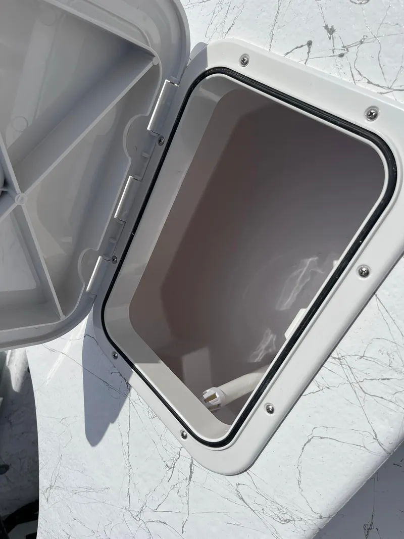Slide: The Image of Open storage compartment on 2025 Coastal Skiff 171 boat. - 12
