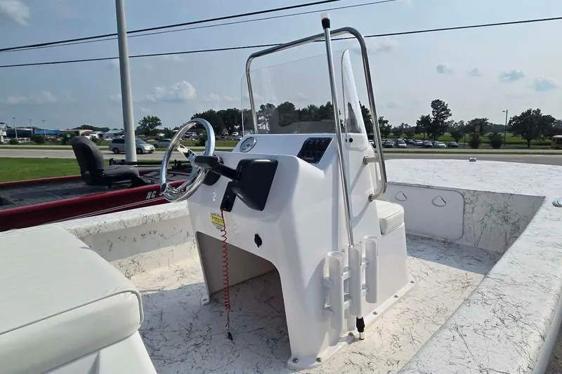 Slide: The Image of 2027 Coastal Skiff 171 boat interior with steering console and seating. - 5