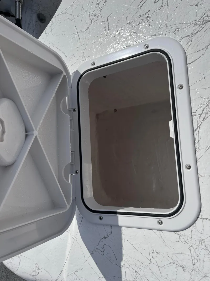 Slide: The Image of Open storage compartment on 2025 Coastal Skiff 171 boat. - 11