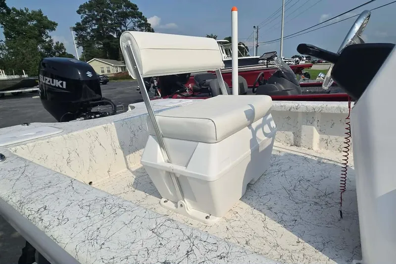 Slide: The Image of 2027 Coastal Skiff 171 boat interior with Suzuki outboard motor, featuring white seating and console. - 16