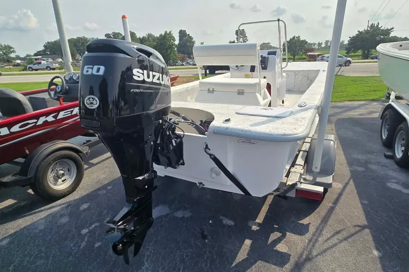 Slide: The Image of 2027 Coastal Skiff 171 boat with Suzuki 60 outboard motor, parked on a trailer. - 4
