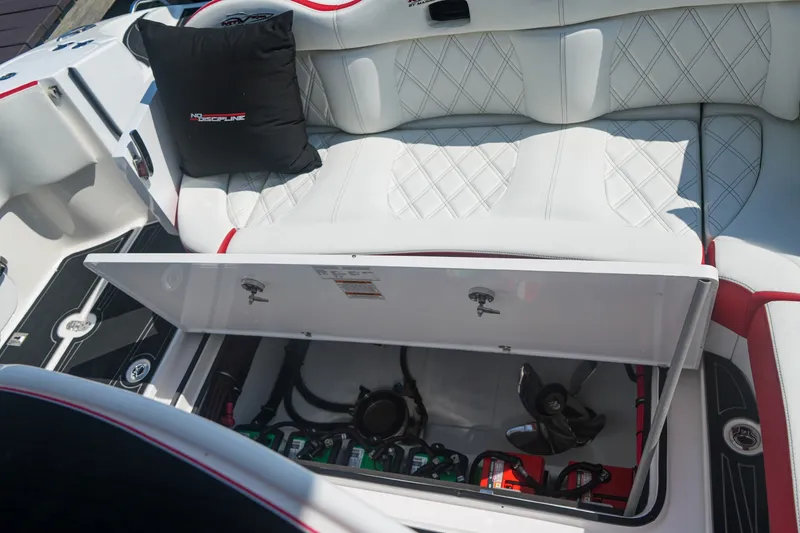 Slide: The Image of 2016 MTI V42 boat interior with open storage compartment and cushioned seating. - 10