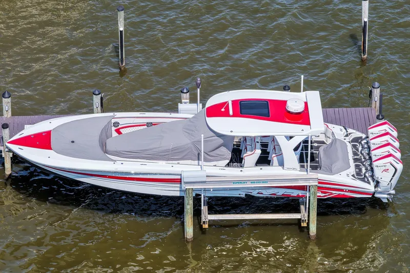 Slide: The Image of 2016 MTI V42 speedboat docked, featuring red and white design with covered seating area. - 3