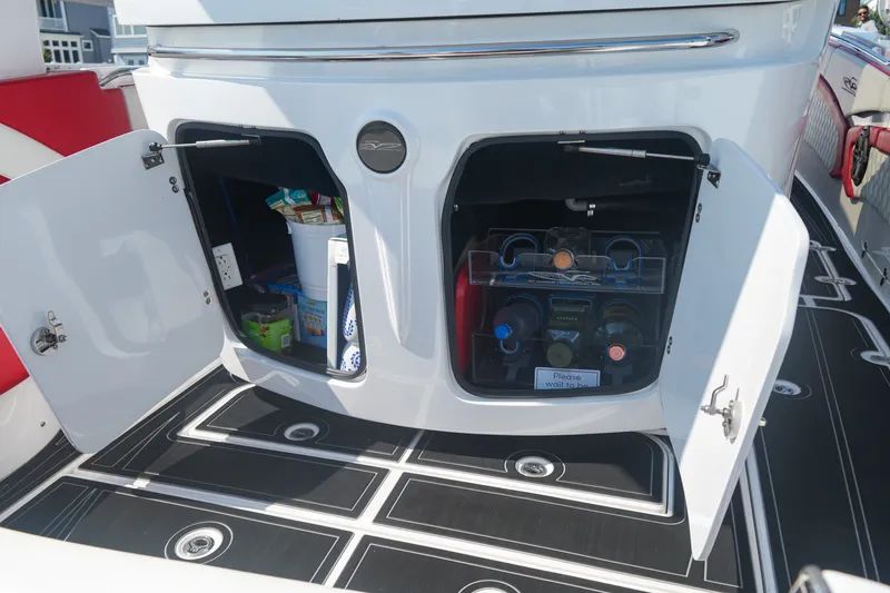 Slide: The Image of Open storage compartments on MTI V42 boat, showcasing organized supplies and beverages. - 12