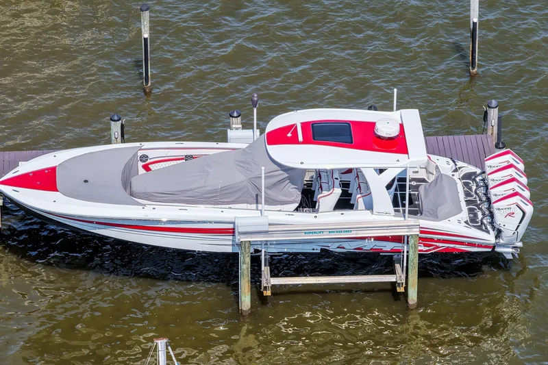 Slide: The Image of 2016 MTI V42 boat docked, featuring red and white design with multiple outboard engines. - 7