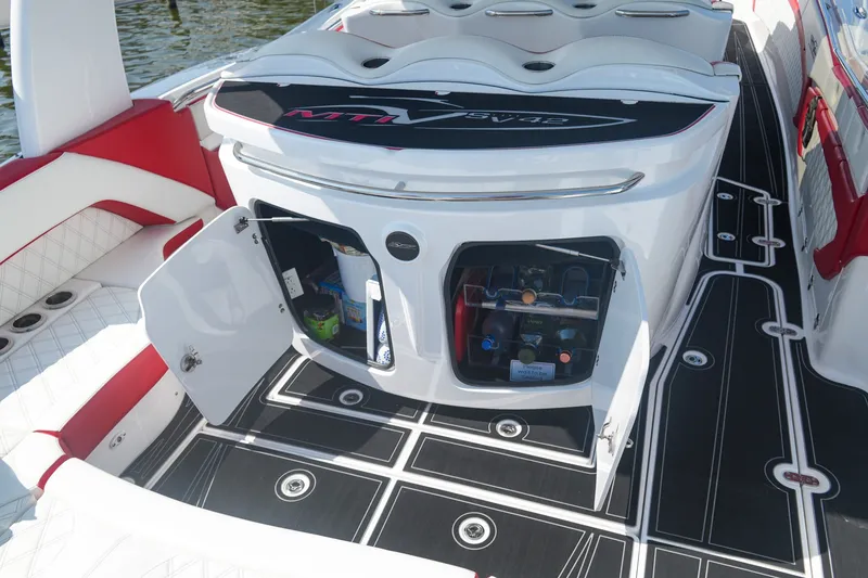 Slide: The Image of Luxury MTI V42 boat interior with open storage compartments, featuring sleek black and white design, 2016 model. - 13