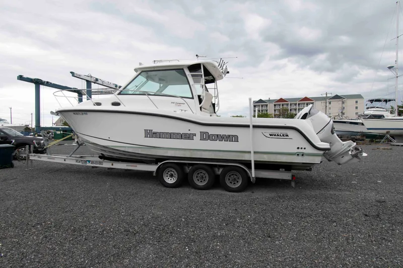 Slide: The Image of 2016 Boston Whaler 315 Conquest boat on trailer, labeled "Hammer Down," in a marina setting. - 5