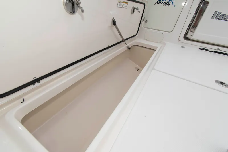 Slide: The Image of Storage compartment on a 2016 Boston Whaler 315 Conquest boat, featuring a clean, white interior. - 29