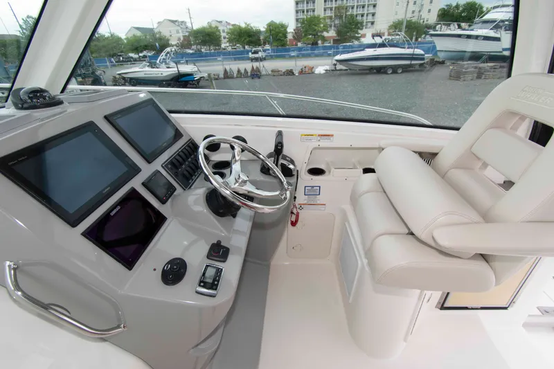 Slide: The Image of 2016 Boston Whaler 315 Conquest helm with modern controls and comfortable seating. - 12