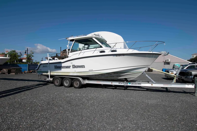 Slide: The Image of 2016 Boston Whaler 315 Conquest boat on trailer in sunny outdoor setting. - 3