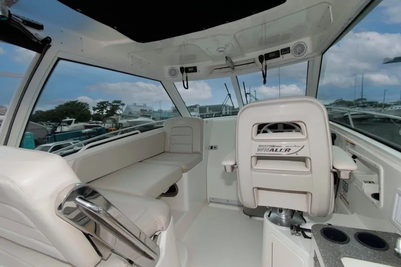 Slide: The Image of Interior of 2016 Boston Whaler 315 Conquest boat with seating and helm. - 9