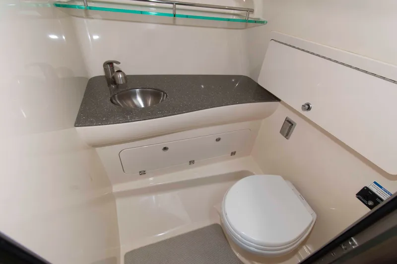 Slide: The Image of 2016 Boston Whaler 315 Conquest bathroom with sink and toilet, featuring modern design. - 28