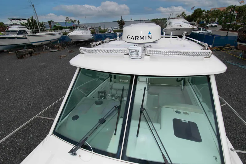 Slide: The Image of 2016 Boston Whaler 315 Conquest with Garmin radar, docked among other boats. - 22