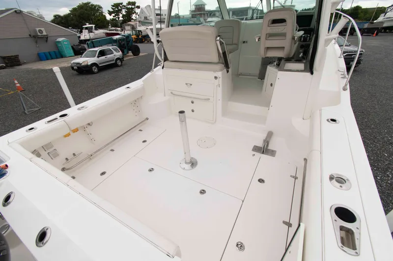 Slide: The Image of 2016 Boston Whaler 315 Conquest boat interior, featuring spacious seating and storage areas. - 7