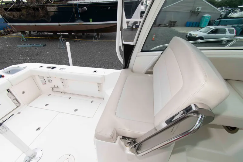 Slide: The Image of 2016 Boston Whaler 315 Conquest interior with seating and deck view. - 17