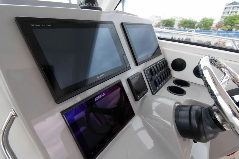 Slide: The Image of Control panel of 2016 Boston Whaler 315 Conquest with Garmin and Simrad displays. - 11