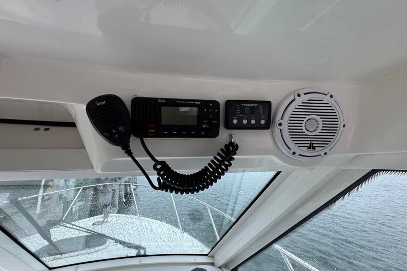 Slide: The Image of 2016 Boston Whaler 315 Conquest cockpit electronics, featuring radio and speaker system. - 5