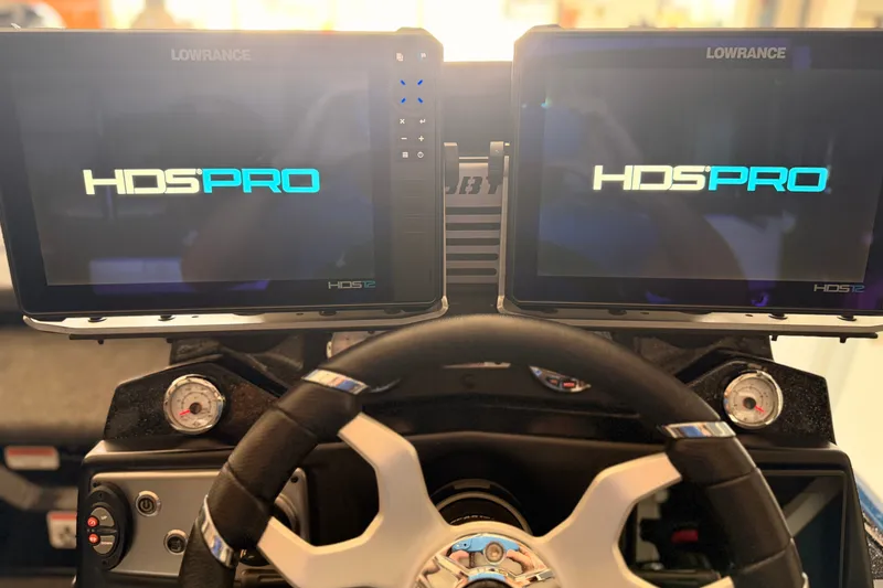Slide: The Image of 2024 TRACKER NITRO Z21XL dashboard with dual Lowrance HDS PRO displays and steering wheel. - 16