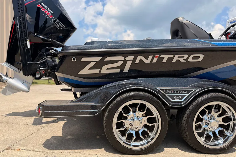 Slide: The Image of 2024 TRACKER NITRO Z21XL boat with dual axle trailer and Mercury Pro XS engine. - 3