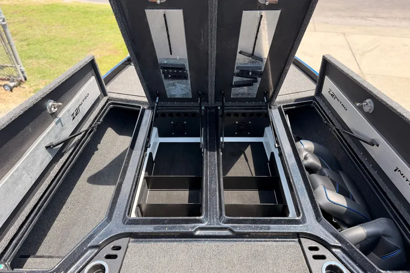 Slide: The Image of 2024 TRACKER NITRO Z21XL boat storage compartments with open lids, showcasing interior design. - 17