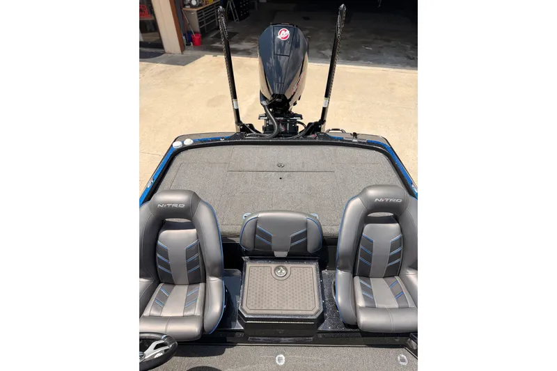 Slide: The Image of 2024 TRACKER NITRO Z21XL boat interior with dual seats and motor view. - 14