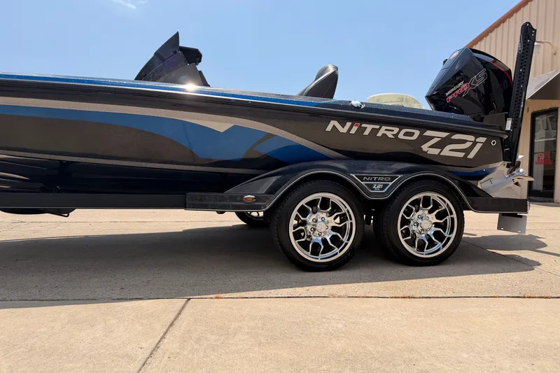 Slide: The Image of 2024 TRACKER NITRO Z21XL boat with sleek design and shiny chrome wheels. - 4
