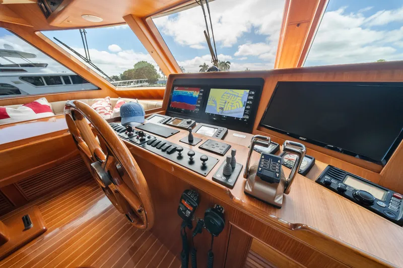 Slide: The Image of Cockpit of 2011 Marlow Explorer 70E yacht with navigation screens and wooden steering wheel. - 19