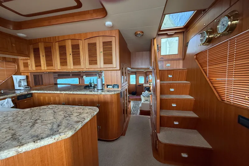 Slide: The Image of Luxurious interior of 2011 Marlow Explorer 70E yacht with wooden cabinetry and granite countertops. - 2
