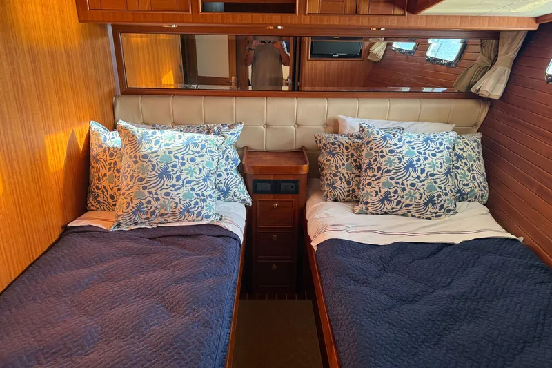 Slide: The Image of Twin beds with floral pillows in 2011 Marlow Explorer 70E cabin. - 6