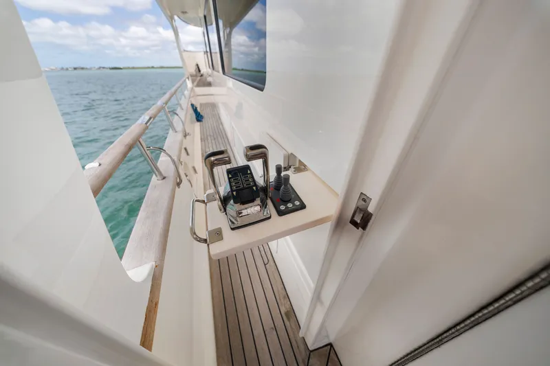 Slide: The Image of Side deck of 2011 Marlow Explorer 70E yacht with control panel, overlooking ocean. - 17