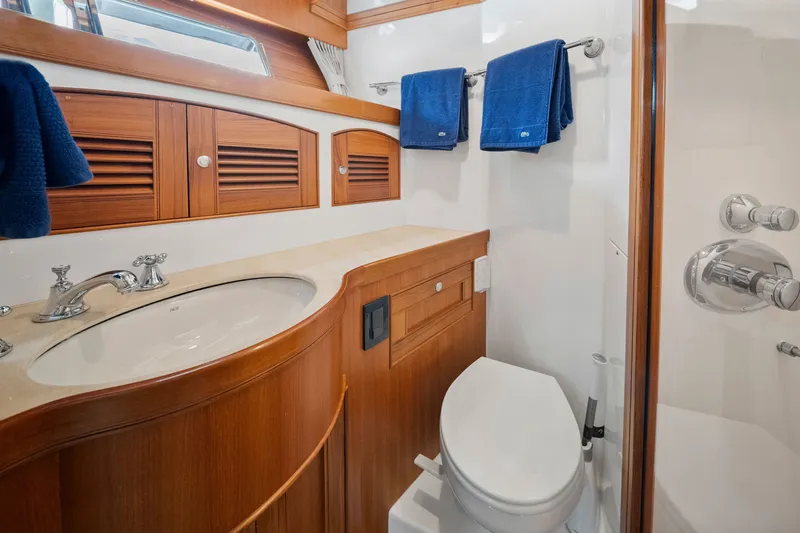 Slide: The Image of Luxurious bathroom in 2011 Marlow Explorer 70E yacht with wooden cabinetry and modern fixtures. - 43