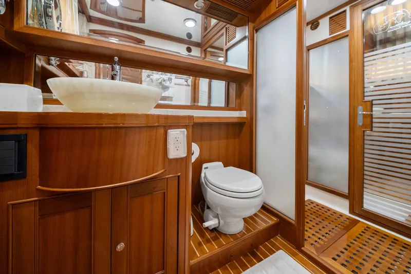 Slide: The Image of Luxurious bathroom in 2011 Marlow Explorer 70E yacht with wooden accents and modern fixtures. - 36