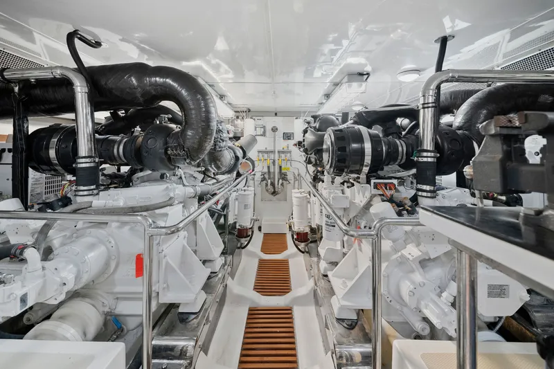 Slide: The Image of Engine room of 2011 Marlow Explorer 70E yacht, showcasing dual engines and mechanical systems. - 49