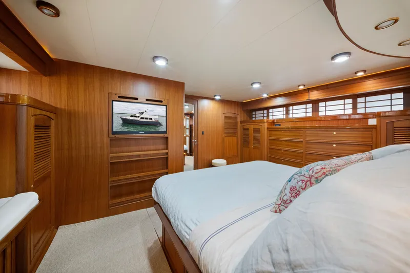 Slide: The Image of Luxurious cabin interior of 2011 Marlow Explorer 70E yacht with wood paneling and cozy bedding. - 33