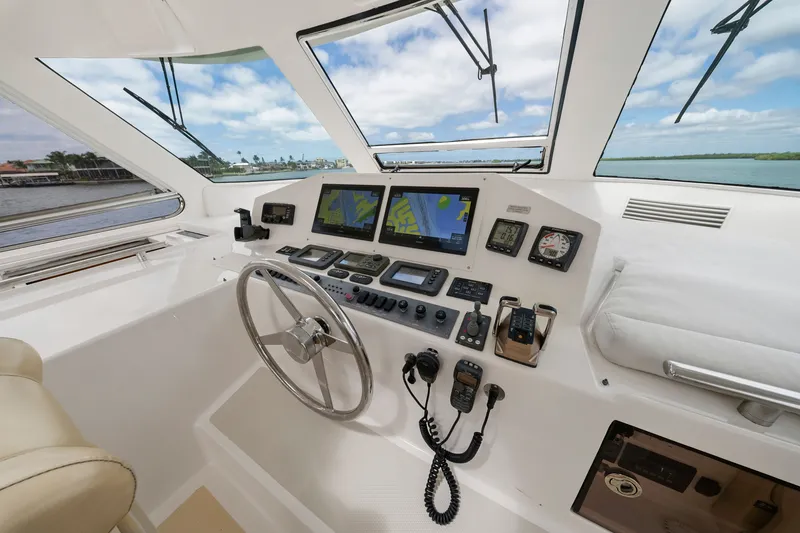 Slide: The Image of Helm of 2011 Marlow Explorer 70E yacht with navigation screens and controls. - 16