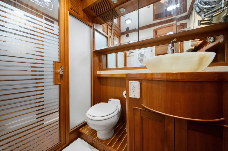 Slide: The Image of Luxurious bathroom on 2011 Marlow Explorer 70E yacht with wooden accents and modern fixtures. - 35