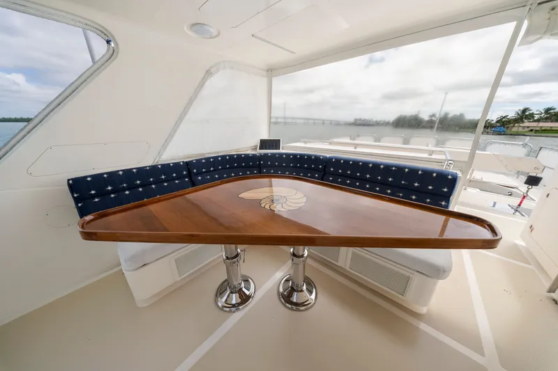 Slide: The Image of Luxurious interior of 2011 Marlow Explorer 70E yacht with elegant wooden table and blue seating. - 15