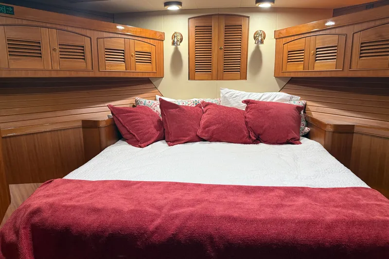 Slide: The Image of Luxurious cabin interior of 2011 Marlow Explorer 70E with plush bedding and wooden accents. - 5