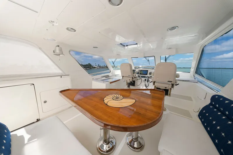 Slide: The Image of Luxurious interior of 2011 Marlow Explorer 70E yacht with elegant wood table and helm station. - 13