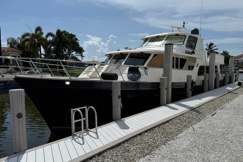 Slide: The Image of Luxury 2011 Marlow Explorer 70E yacht docked at marina under clear sky. - 8