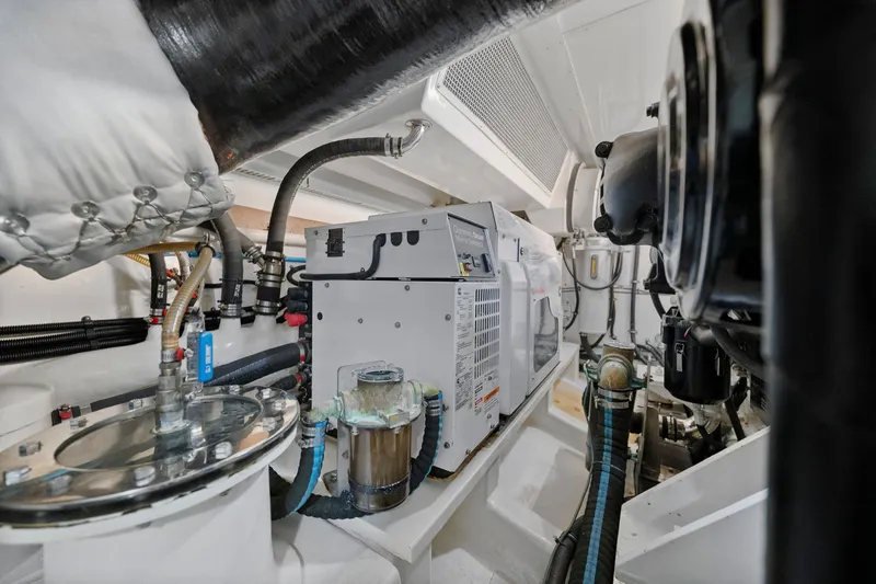Slide: The Image of Engine room of 2011 Marlow Explorer 70E yacht with mechanical components and piping. - 50