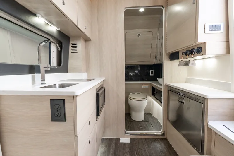 Slide: The Image of Luxurious 2022 Scout 425 LXF boat interior with modern kitchen and bathroom amenities. - 35