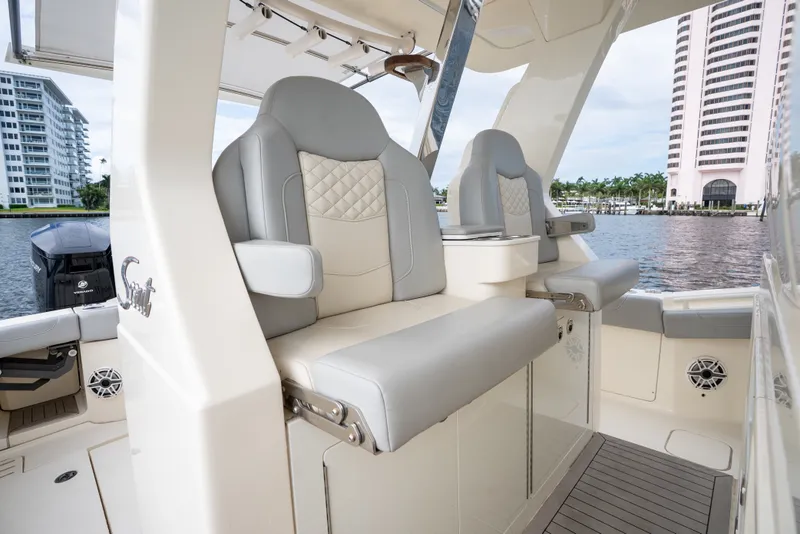 Slide: The Image of 2022 Scout 425 LXF boat interior with luxurious seating and waterfront view. - 24