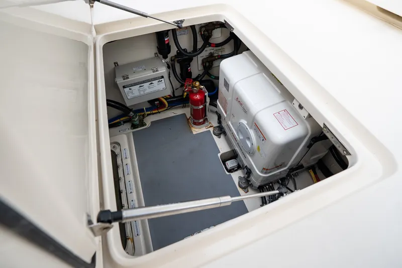 Slide: The Image of Engine compartment of 2022 Scout 425 LXF boat, featuring equipment and fire extinguisher. - 29