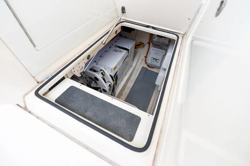 Slide: The Image of 2022 Scout 425 LXF boat storage compartment with electrical components and wiring. - 26