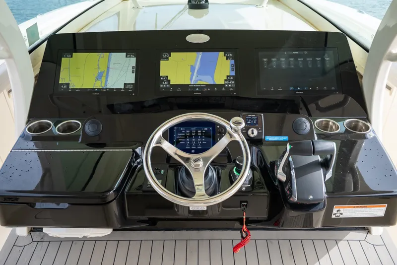 Slide: The Image of 2022 Scout 425 LXF boat dashboard with navigation screens and steering wheel. - 19